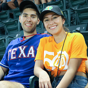 Couple sitting at a Texas Rangers game