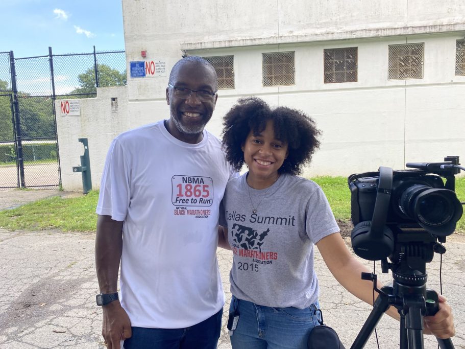Tony Reed posing with videographer Kayla Key for a picture during filming of a documentary.