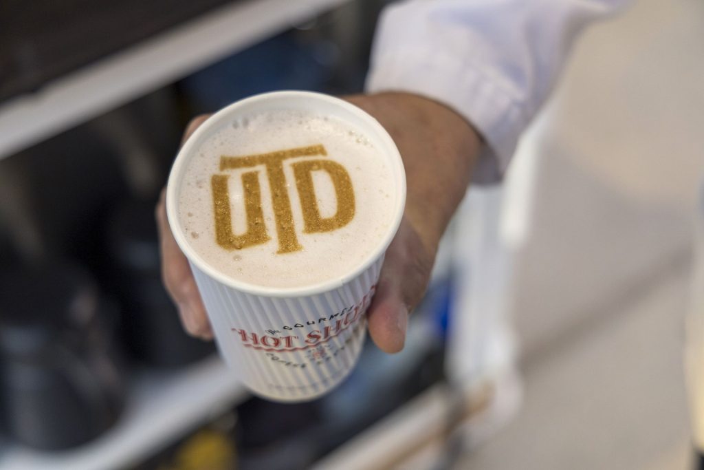 Coffee foam with the UTD logo.