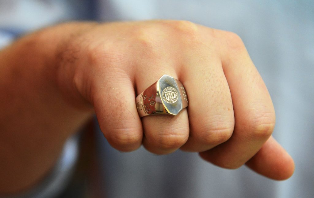 Hand with UT Dallas ring.