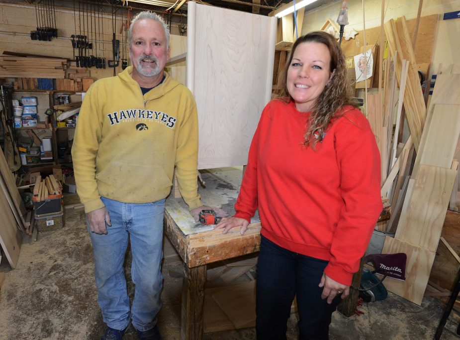 Tim and Heather Jones posing for a photo in the THH Creations wood shop.