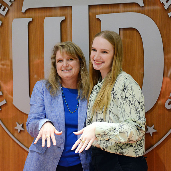 Mother Dana Loucks and daughter Jessica Loucks posing with their UT Dallas rings.