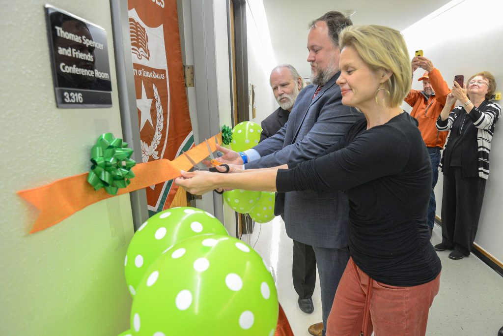 Jay Scott and Thomas and Lily Spencer cutting ribbon to newly named conference room.