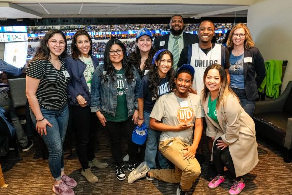 Group photo of UT Dallas Chime Scholarship recipients at a Dallas Mavericks basketball game.