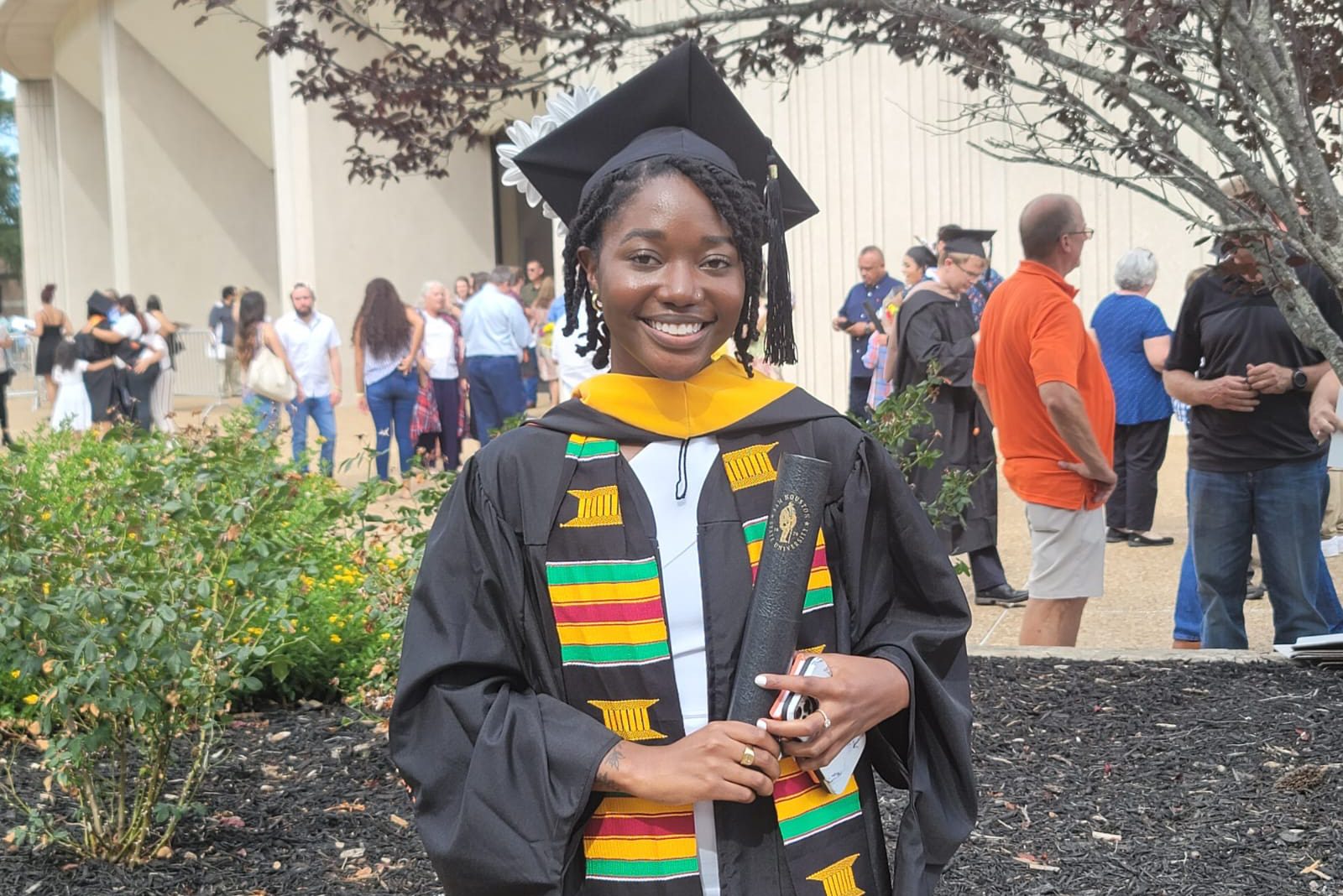 Portrait of Annette Addo-Yobo posing in her graduation regalia.