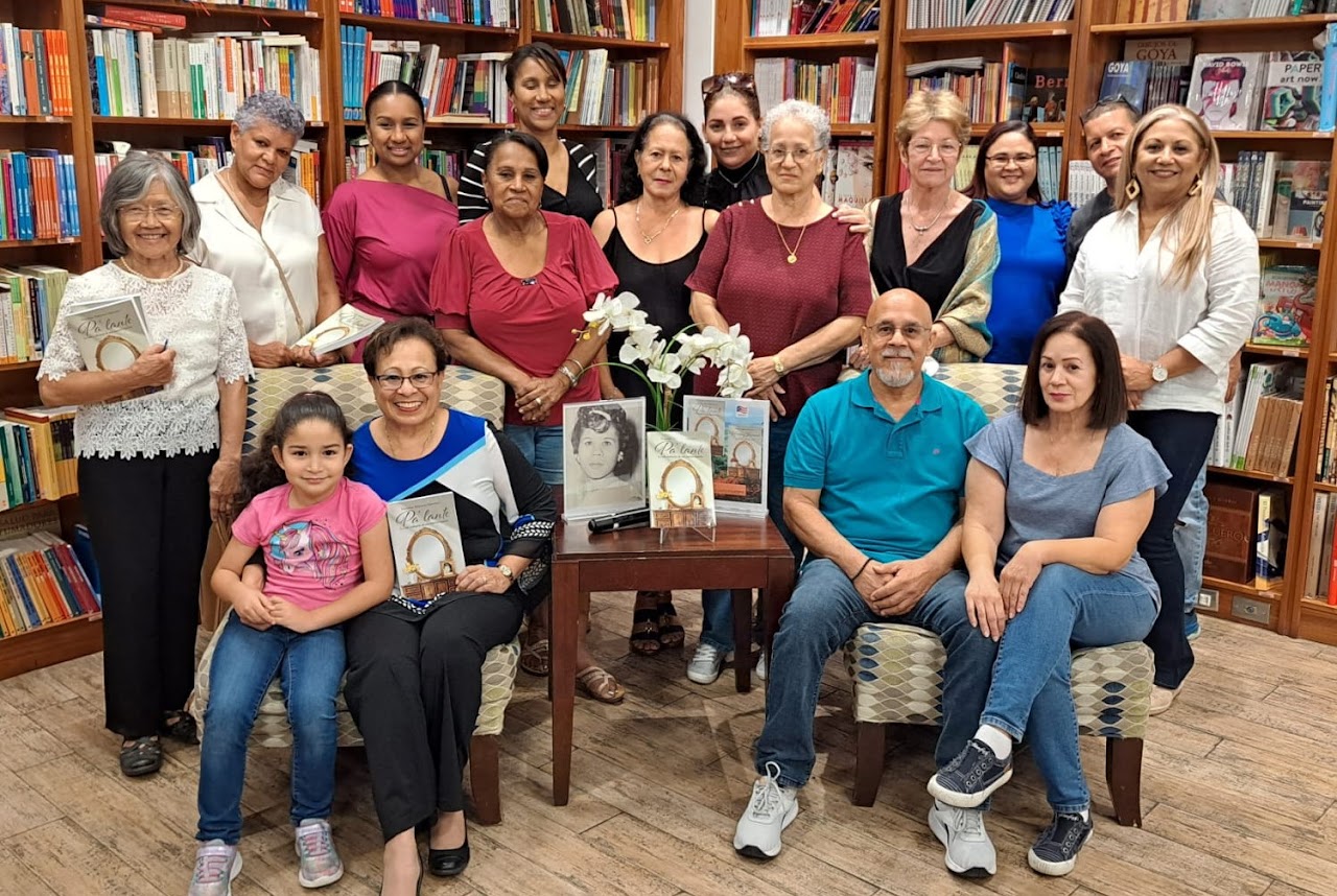 Yolanda Medina posing for a picture with her family inside a library.
