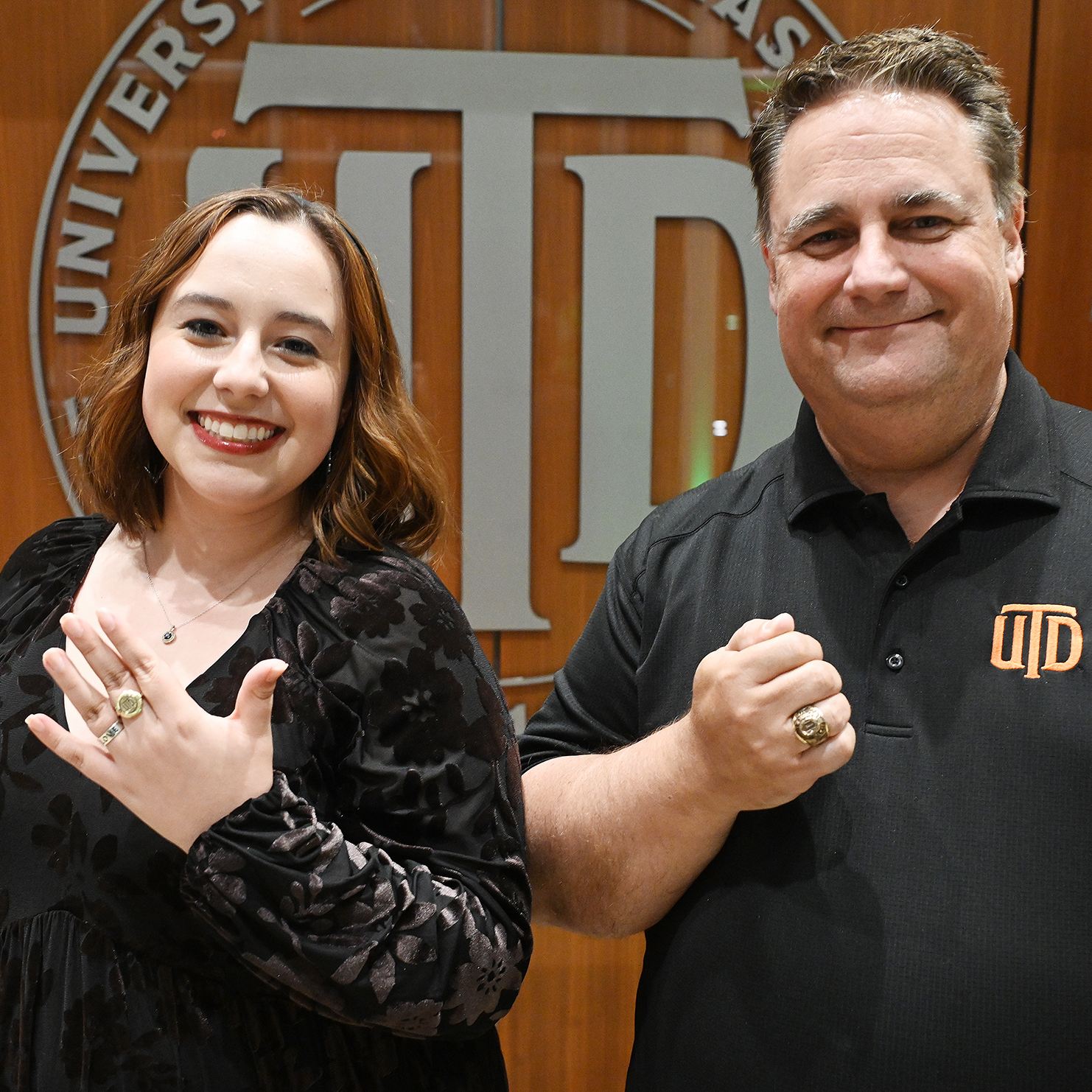 Father and daughter pose for a picture with their UTD ring.